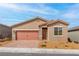Inviting single-story home featuring a two-car garage, desert landscaping, and a neutral color palette at 6737 Lotus Vista Ct, Las Vegas, NV 89156