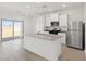 Contemporary kitchen featuring an island, stainless appliances, and sliding door access to the yard at 6737 Lotus Vista Ct, Las Vegas, NV 89156