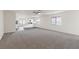 Spacious open-concept living area with carpet and laminate flooring at 6743 Violet Cascade Ave, Las Vegas, NV 89156