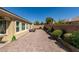Spacious backyard features a brick-paved area, lush landscaping and privacy wall at 7349 Royal Melbourne Dr, Las Vegas, NV 89131