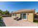 Spacious backyard featuring brick-paved area, seating, and sliding glass doors at 7349 Royal Melbourne Dr, Las Vegas, NV 89131