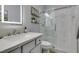 Bright bathroom with a glass-enclosed shower, a white vanity and modern fixtures at 7349 Royal Melbourne Dr, Las Vegas, NV 89131