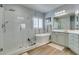 Relaxing bathroom with a glass shower, a soaking tub, neutral colors and wood look floors at 7349 Royal Melbourne Dr, Las Vegas, NV 89131