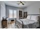 Comfortable bedroom featuring a metal bed frame, gray bedding, and a stylish cabinet and a window at 7349 Royal Melbourne Dr, Las Vegas, NV 89131