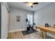 Well-lit home gym area with an exercise bike, a desk and a sliding barn door at 7349 Royal Melbourne Dr, Las Vegas, NV 89131