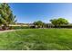 Well-manicured community park with green grass, mature trees, and pergola at 7349 Royal Melbourne Dr, Las Vegas, NV 89131