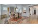 Dining room with a wooden table, seating for eight, and bright natural light at 7349 Royal Melbourne Dr, Las Vegas, NV 89131