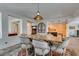Charming dining area featuring a wooden table with upholstered chairs and stylish lighting at 7349 Royal Melbourne Dr, Las Vegas, NV 89131