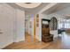 Elegant home foyer featuring wood floors, a decorative bench, and an open floor plan at 7349 Royal Melbourne Dr, Las Vegas, NV 89131