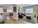 Bright and open living room featuring wood floors, plantation shutters, and modern decor at 7349 Royal Melbourne Dr, Las Vegas, NV 89131