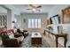 Cozy living room with comfortable seating, wood floors, plantation shutters, and a modern TV at 7349 Royal Melbourne Dr, Las Vegas, NV 89131