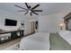 Comfortable main bedroom featuring a ceiling fan, wooden furniture and neutral decor at 7349 Royal Melbourne Dr, Las Vegas, NV 89131