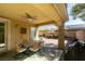 Covered patio boasts a dining table, ceiling fan and ample space to relax and dine al fresco at 7349 Royal Melbourne Dr, Las Vegas, NV 89131