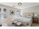 Bright bedroom features neutral walls, wood floors, tufted headboard, and stylish decor for a serene retreat at 7566 Hope Valley St, Las Vegas, NV 89139
