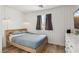 Modern bedroom with white wood-paneled walls, natural light, and minimalist design for a calming ambiance at 7566 Hope Valley St, Las Vegas, NV 89139