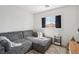 Cozy room with sectional sofa, plush rug, and natural light creates a comfy space for relaxation at 7566 Hope Valley St, Las Vegas, NV 89139