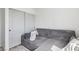 A bedroom showcasing gray corduroy sofa and minimalistic decor, offering cozy style and space at 7566 Hope Valley St, Las Vegas, NV 89139