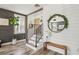 Stylish entryway with wood-look floors, staircase, modern mirror, and chic decor welcomes you home at 7566 Hope Valley St, Las Vegas, NV 89139