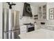 Bright, airy kitchen with an island, white cabinets, marble countertops, stainless steel appliances at 7566 Hope Valley St, Las Vegas, NV 89139