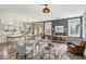 Bright, open kitchen features chandeliers, stainless appliances, white cabinetry, and center island dining at 7566 Hope Valley St, Las Vegas, NV 89139