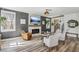 Comfortable living room with a fireplace, staircase, stylish seating, and ample natural light at 7566 Hope Valley St, Las Vegas, NV 89139