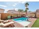 Backyard pool features palm trees, patio furniture, and a lush outdoor space for relaxation and entertainment at 7566 Hope Valley St, Las Vegas, NV 89139