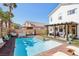 Backyard with pool, patio, and pergola, surrounded by privacy fencing and artificial turf at 7566 Hope Valley St, Las Vegas, NV 89139