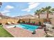 Beautiful pool with brick trim, adjacent to lush landscaping, offers a serene backyard oasis at 7566 Hope Valley St, Las Vegas, NV 89139