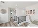 Upstairs landing with a small desk, photos on the wall, and wrought iron railing at 7566 Hope Valley St, Las Vegas, NV 89139