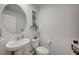 Elegant half bathroom featuring a pedestal sink and decorative elements at 759 Pickled Pepper Pl, Henderson, NV 89011