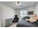 Cozy bedroom featuring a study desk, a window, and a neutral color scheme at 759 Pickled Pepper Pl, Henderson, NV 89011
