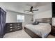 Well-lit bedroom featuring a king-size bed, dark wood furniture, and a ceiling fan at 759 Pickled Pepper Pl, Henderson, NV 89011