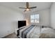 Cozy bedroom with a ceiling fan, window, and a large TV for relaxation and entertainment at 759 Pickled Pepper Pl, Henderson, NV 89011