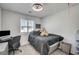 Cozy bedroom features a comfortable bed, a desk, and natural light from the window at 759 Pickled Pepper Pl, Henderson, NV 89011