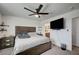 Bedroom with dark wood furniture, ceiling fan, and TV at 759 Pickled Pepper Pl, Henderson, NV 89011