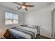 Inviting bedroom features a ceiling fan, a window with blinds, and a comfortable bed with plush pillows at 759 Pickled Pepper Pl, Henderson, NV 89011