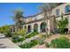 View of a townhome with manicured landscaping, arched entryways, and beautiful facade at 759 Pickled Pepper Pl, Henderson, NV 89011