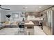 Open kitchen with stainless steel appliances, brown cabinets, and an island flowing into the living area at 759 Pickled Pepper Pl, Henderson, NV 89011