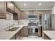Modern kitchen with stainless appliances, countertops, and stylish cabinetry, perfect for cooking and entertaining at 759 Pickled Pepper Pl, Henderson, NV 89011
