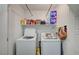 Laundry room with a washer, dryer, and shelving for storage at 759 Pickled Pepper Pl, Henderson, NV 89011