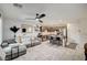 Bright open-concept living area featuring tile flooring, a ceiling fan, and stylish modern furnishings at 759 Pickled Pepper Pl, Henderson, NV 89011