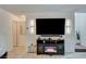 Living room view highlighting sleek wall sconces, a modern TV console and tiled floors at 759 Pickled Pepper Pl, Henderson, NV 89011