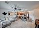 Bright open-concept living area featuring tile flooring, a ceiling fan, and stylish modern furnishings at 759 Pickled Pepper Pl, Henderson, NV 89011