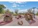 Community playground with rock climbing features and rope climbing web under a cloudy blue sky at 759 Pickled Pepper Pl, Henderson, NV 89011