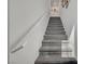 Carpeted staircase leading to the upper level with a sleek, white handrail at 759 Pickled Pepper Pl, Henderson, NV 89011