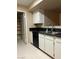 This kitchen is equipped with white cabinets and dark countertops at 7885 W Flamingo Rd # 1064, Las Vegas, NV 89147