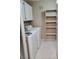 The laundry room has a washer, dryer and storage shelving for convenience at 7885 W Flamingo Rd # 1064, Las Vegas, NV 89147