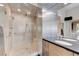 Modern bathroom showcases a sleek shower, dual sinks, custom cabinets and ample space, blending style and functionality at 8121 Castle Pines Ave, Las Vegas, NV 89113