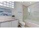 Bright bathroom with toilet, shower-bathtub combo and glass block window accents at 8121 Castle Pines Ave, Las Vegas, NV 89113