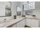 Bright bathroom with double sinks, marble countertop and glass block windows at 8121 Castle Pines Ave, Las Vegas, NV 89113